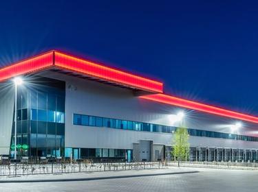 Exterior photo of XPO Logistics BTS Eindhoven, Netherlands at night.