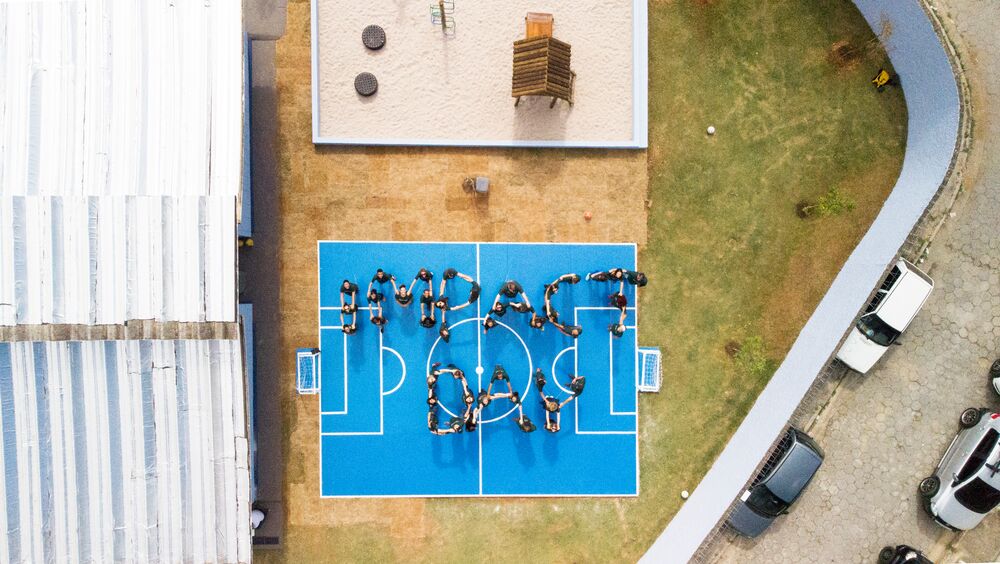 A creative image for Prologis Impact Day with employees holding hands to spell the words.