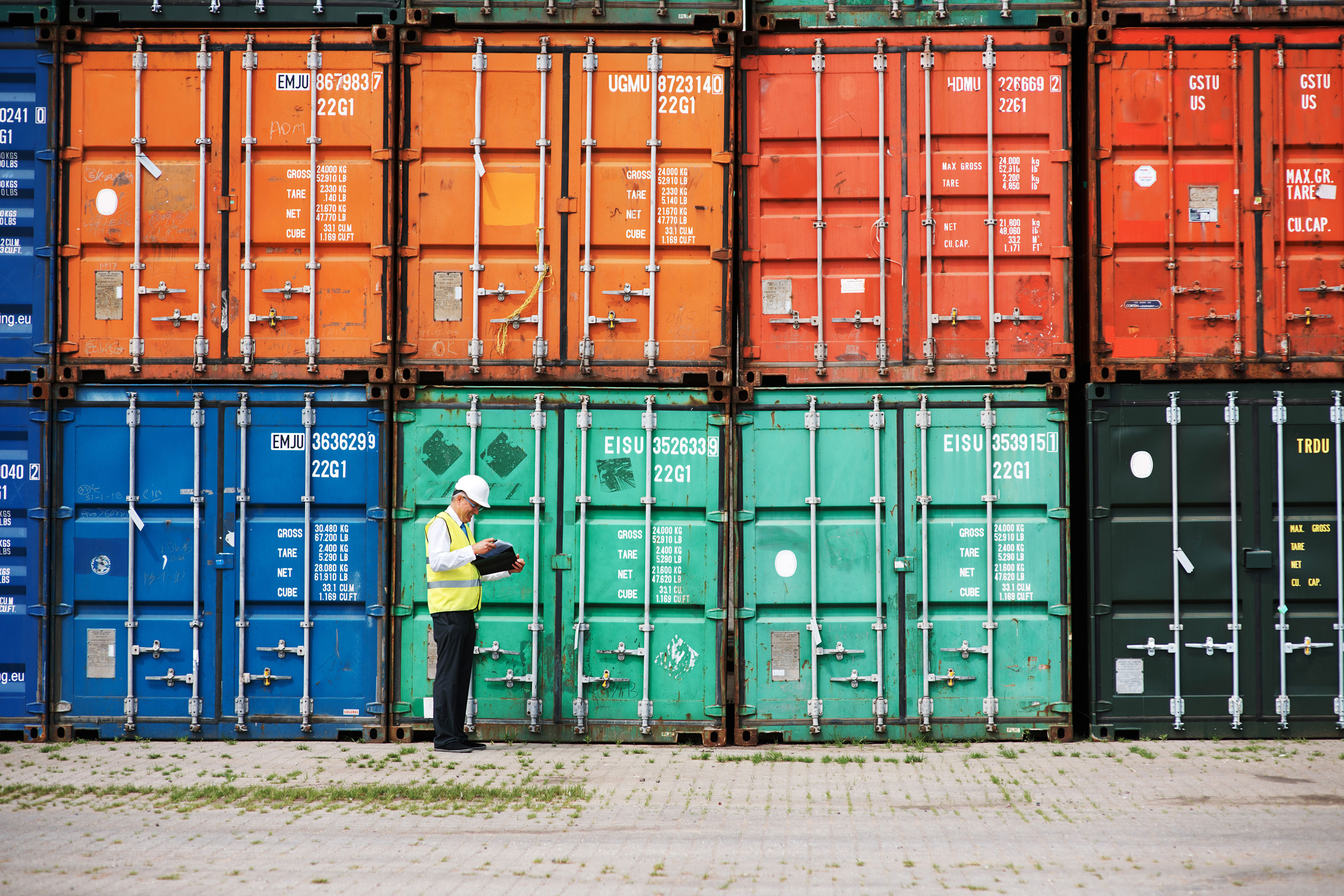 Man standing near shipping containers
