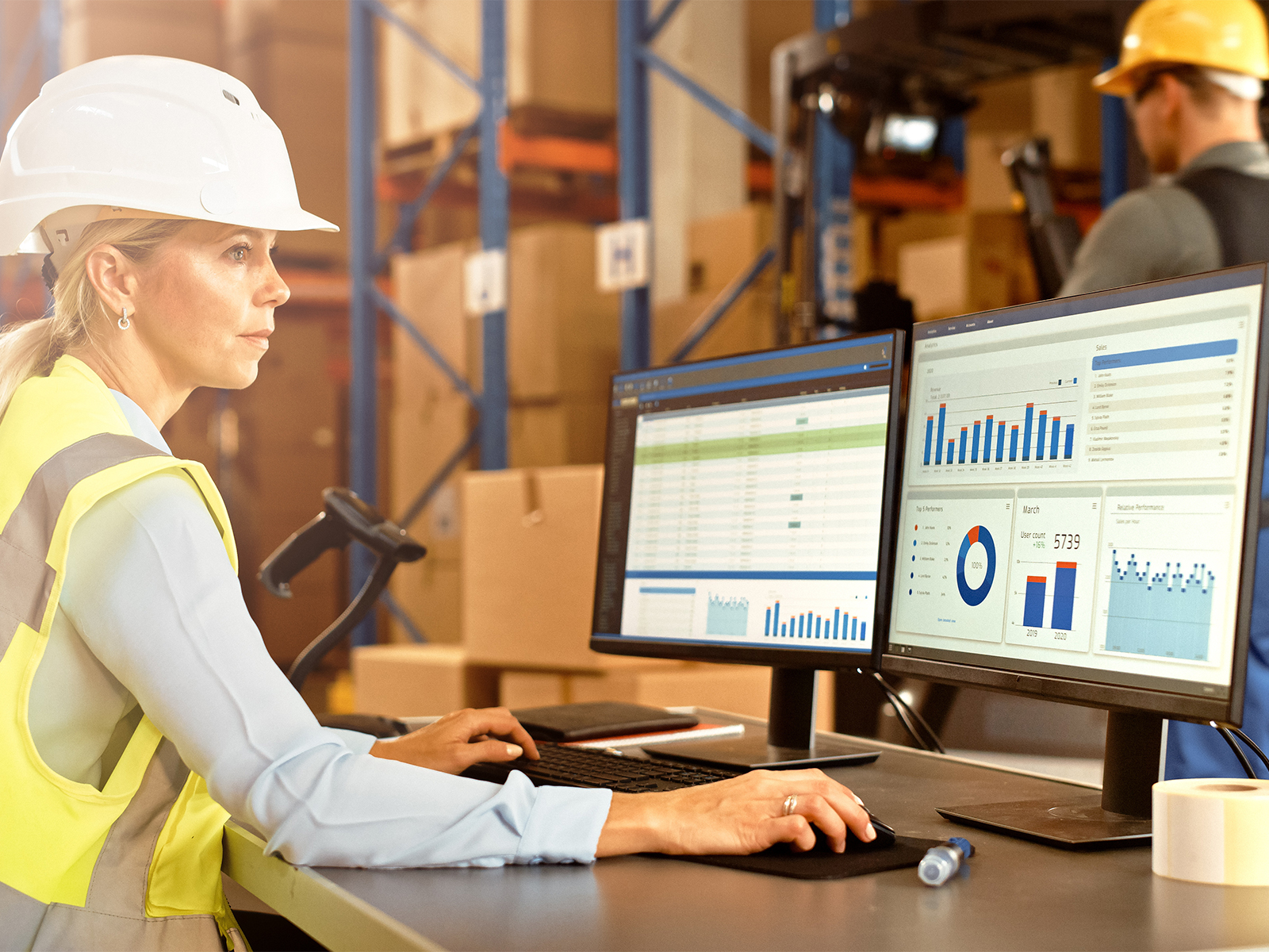 Woman working in warehouse on computer