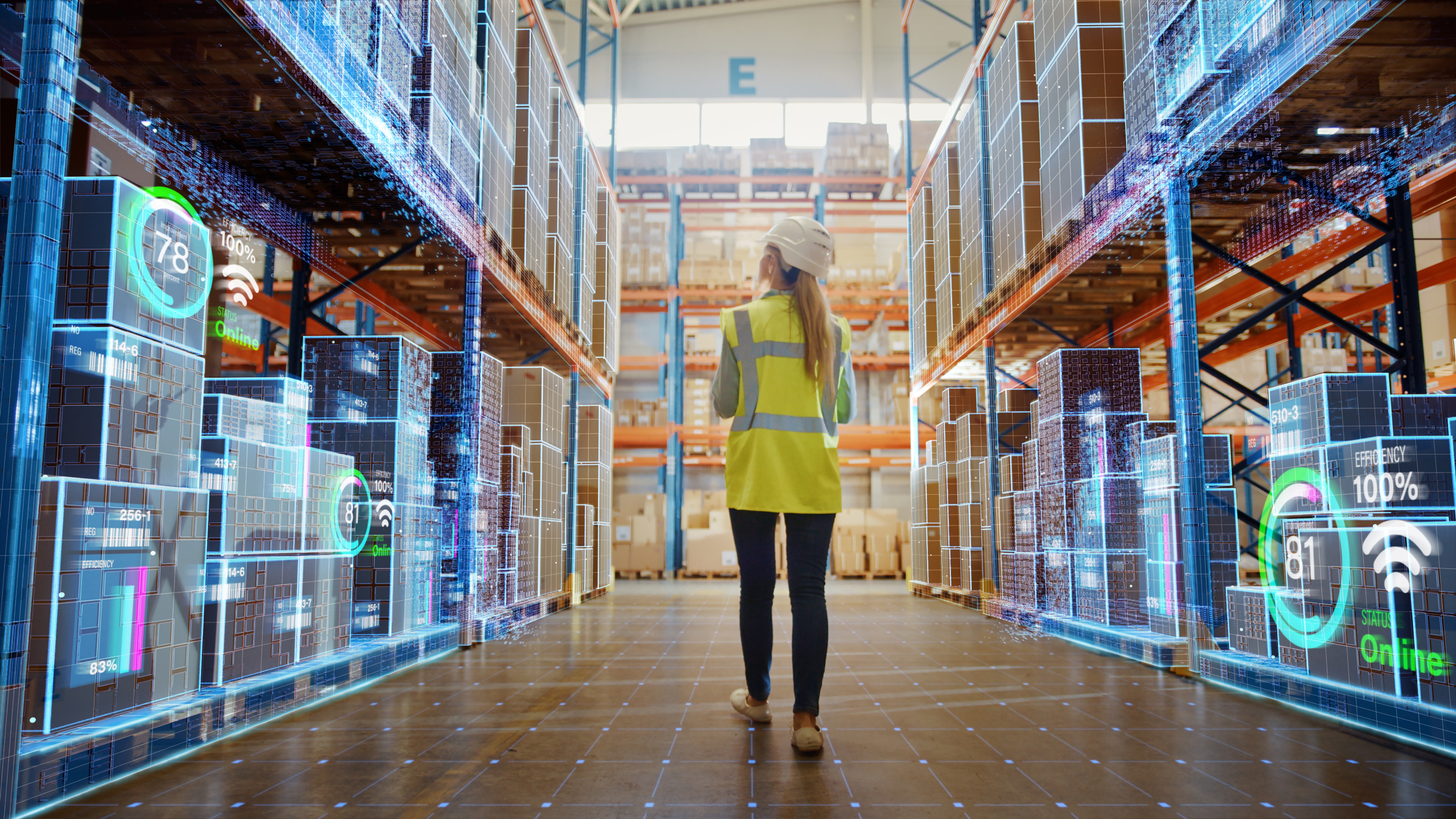 Woman walking through a warehouse with graphical representations of technology connectivity
