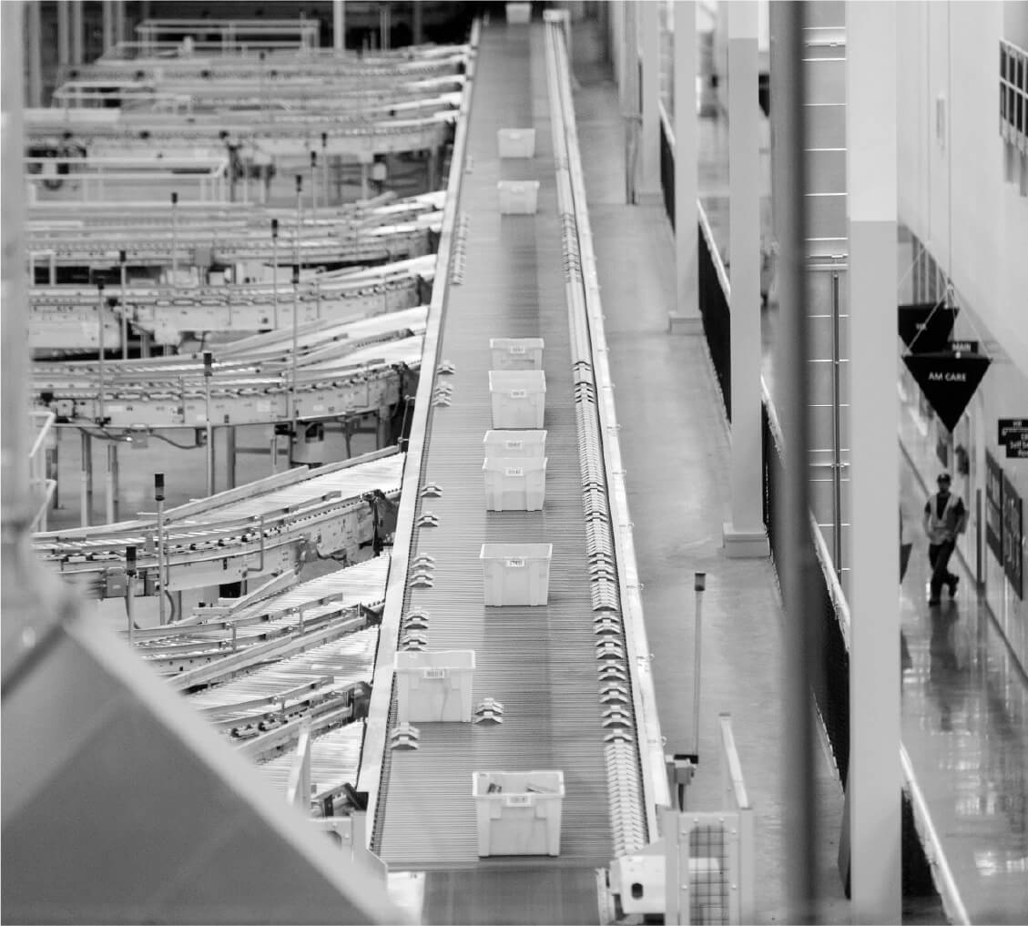 Totes on a conveyor belt in a fulfillment center
