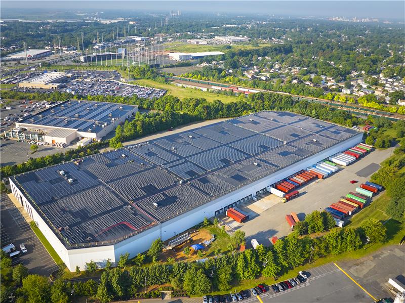 An aerial view of a warehouse with solar panels