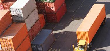 A photo of stacked shipping containers frfom above