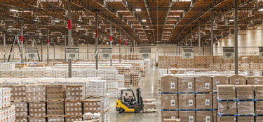 A worker drives a forklift inside the distribution center in Kaiser, CA