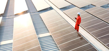 Solar workers on roof with solar panels