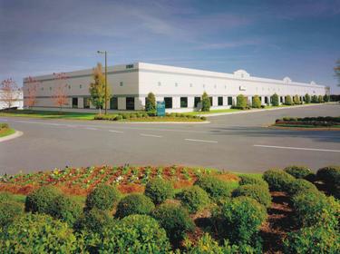 Prologis Timeline - 1999 Exterior photo of an AMB building and parking lot in Charlotte, NC 