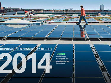 Workers installing solar panels on a warehouse rooftop