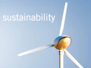 A photo of a windmill with the word "sustainability"