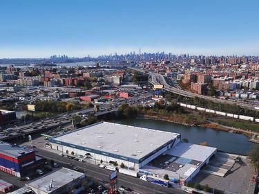 An aerial shot of Prologis Bronx I and the surrounding area, with the NYC skyline in the background
