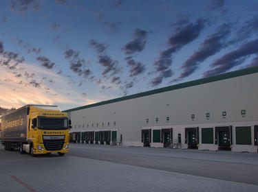An exterior shot of the building and a truck in the truck court of Prologis Budapest Sziget DC8