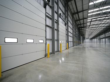 Photo of dock doors inside of an empty warehouse
