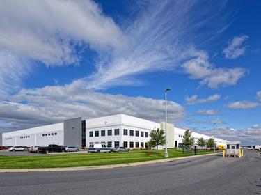 An exterior shot of Prologis Park 33, with cars parked outside