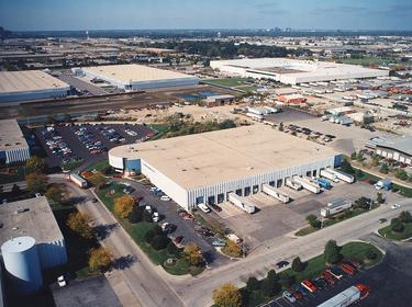 An exterior aerial shot of Prologis Bensenville Industrial Park, with full parking lots and busy truck courts