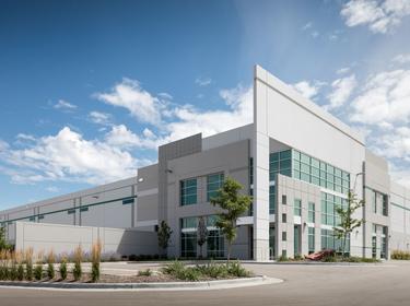The front entrance of Prologis Business Center North with the dock doors and truck courts on the left side of the images, and landscaping and a parking lot to the right.