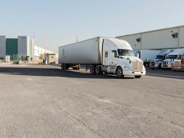 A photo of a sem-truck at Prologis Tres Rios 3. A security gate and other semi-trucks are in the background.