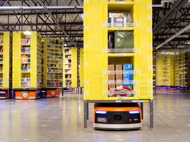 Orange Automated Mobile Robots (AMR) help move goods at Prologis International Park of Commerce, Tracy, California