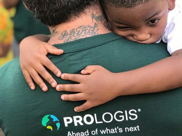 A Prologis employee hugging a young boy for IMPACT Day 2019