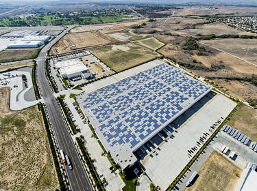 Aerial angled warehouse exterior view with solar panels on the roof of Prologis Meridian 1 in Riverside, California