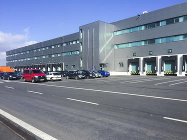 Exterior view of parking lot and loading area for a standalone building