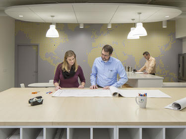 Two team members review blueprints in the Columbus office