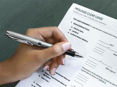 Woman's left hand holding a pen ready to fill out a Prologis Clear Lease