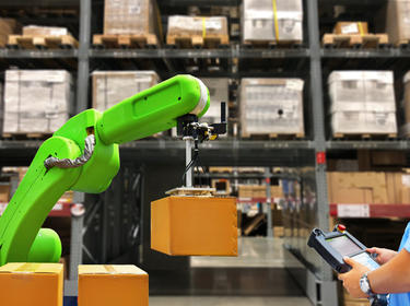 Robot carries box in warehouse