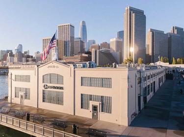 A photo of the Prologis corporate office at Piere 1 in San Francisco. The Prologis logo is displayed on the back of the building, and in the background is the San Francisco skyline.