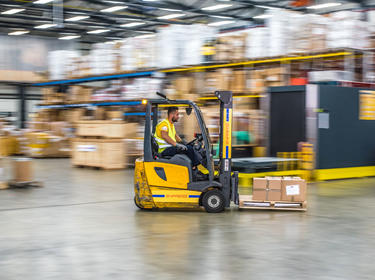 Warehouse employee on a forklift
