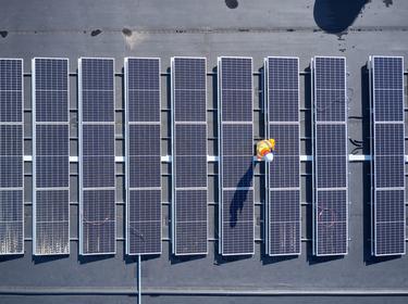 Overhead view of Solar panels on warehouse roof. 