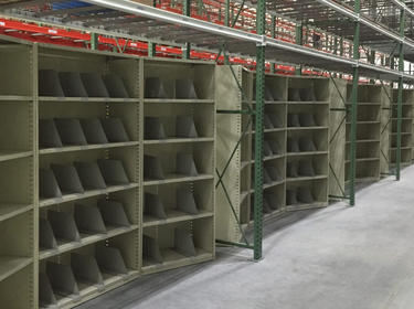 Curved industrial shelving in a warehouse