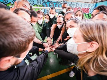 Group of Prologis employees huddle together to celebrate Impact Day