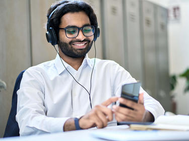 Man with headphones listening to podcast