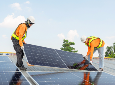 solar panels being installed by two men