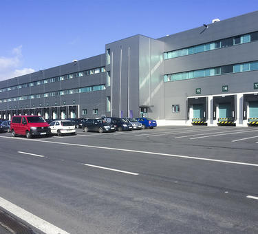 Exterior view of parking lot and loading area for a standalone building