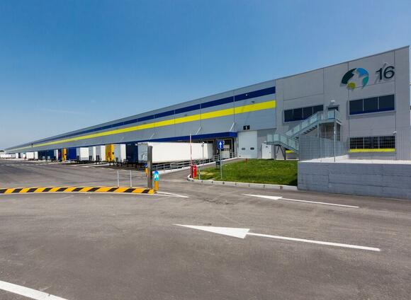 An exterior shot of Prologis Bologna Interporto DC16 with trucks parked in the truck court