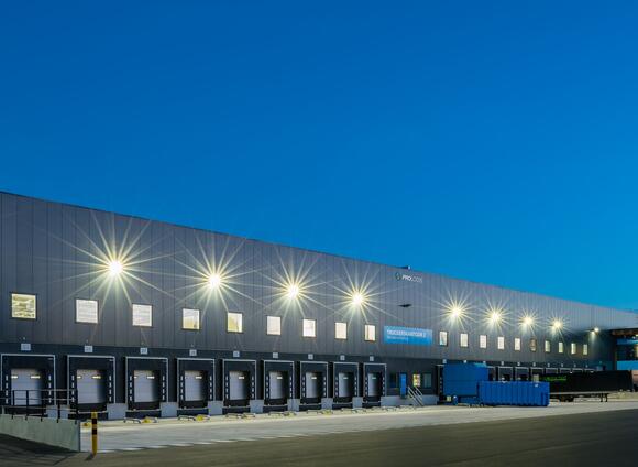 An exterior photo of the dock doors and truck court at Prologis Tilburg DC4 at dusk