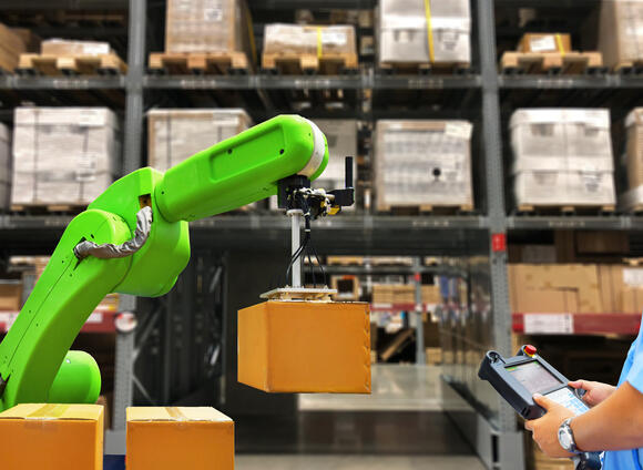 Robot carries a box in a warehouse