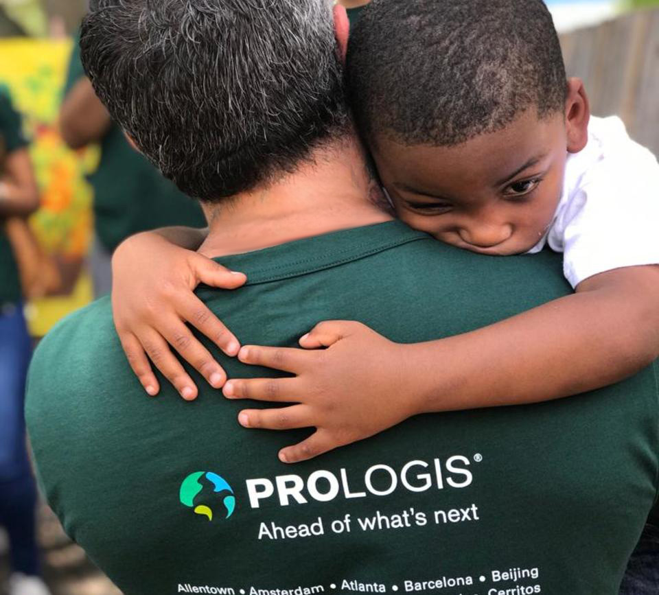 Child hugs a Prologis Employee on IMPACT Day Child hugs a Prologis Employee on IMPACT Day