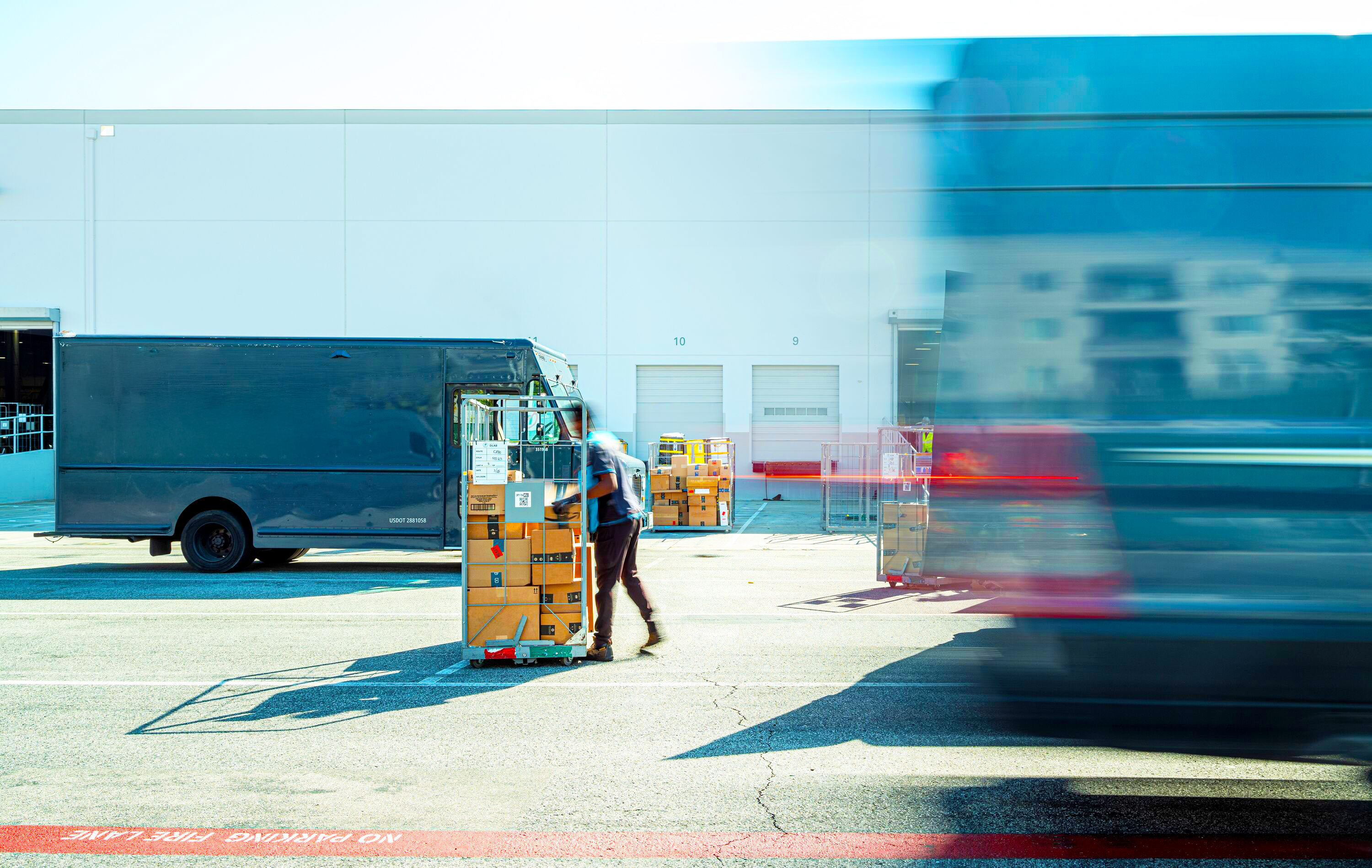 Person moving a pallet at the exterior of a building