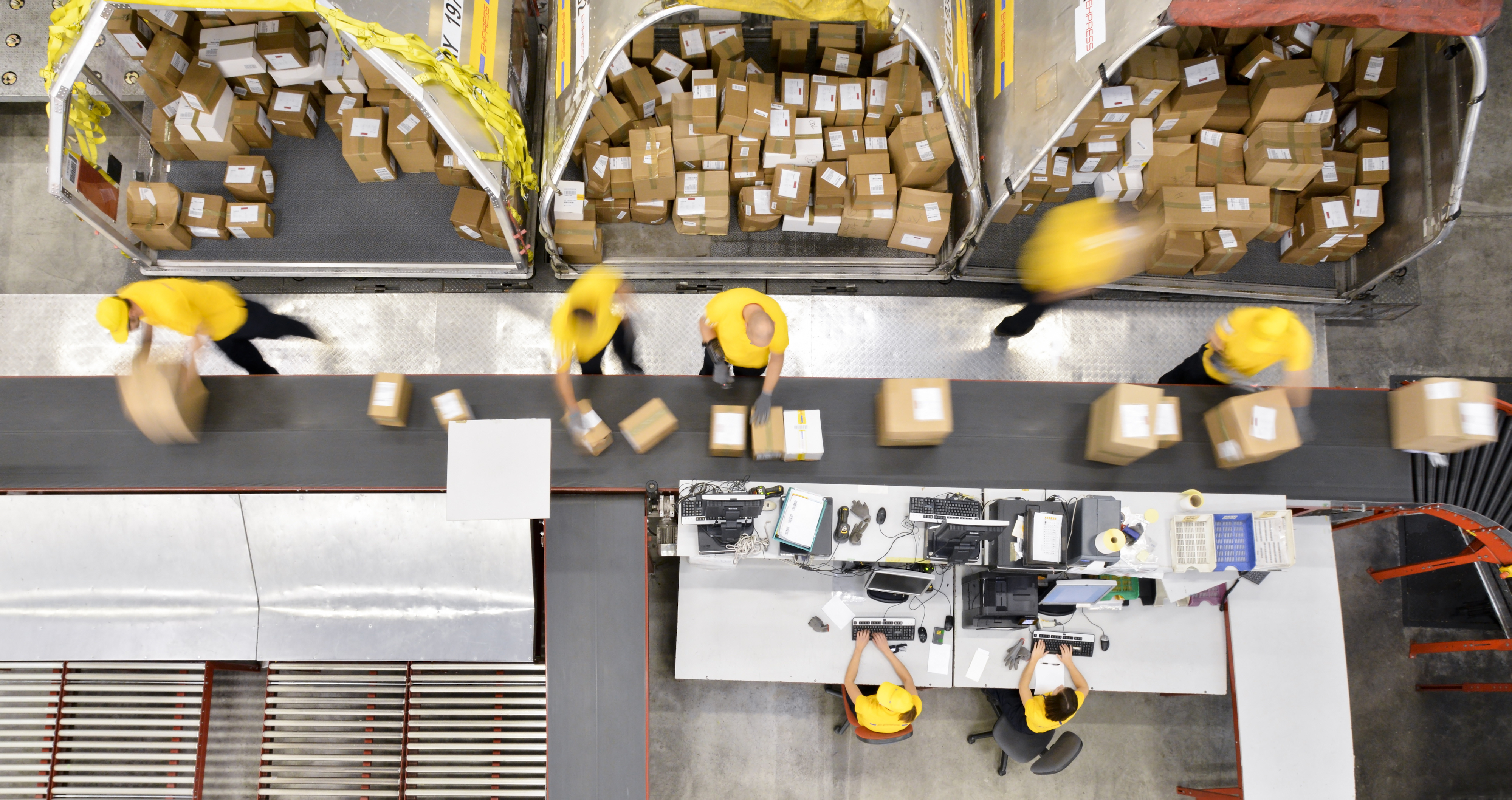 Overhead view of workers processing packages