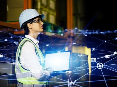 Female worker in a warehouse with tech graphics