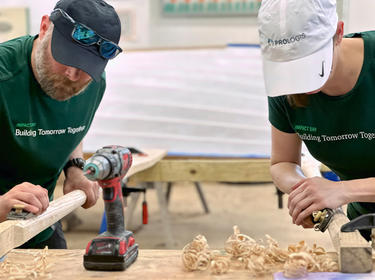 Two Prologis employees sanding wood at an IMPACT Day project Two Prologis employees sanding wood at an IMPACT Day project