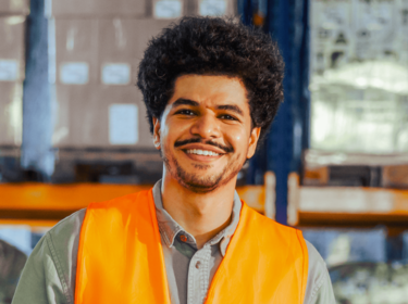 Man smiling wearing an orange vest Man smiling wearing an orange vest