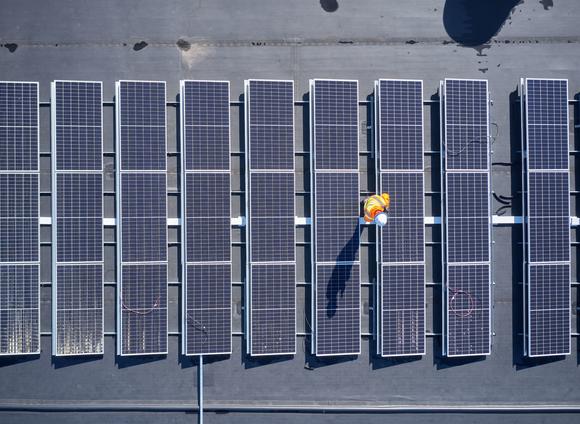 Overhead view of Solar panels on warehouse roof. 